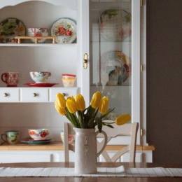 a table with flowers and shelving