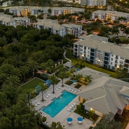 Resort-style swimming pool with lounge seating